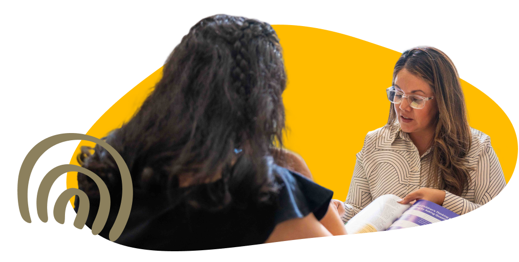 two people reading a workbook