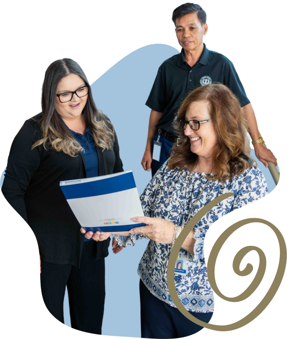 three people looking at a document