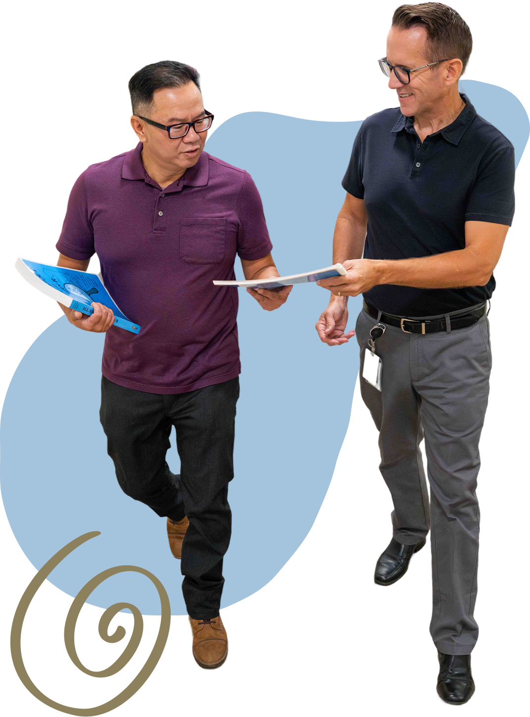 two people standing looking at notebooks