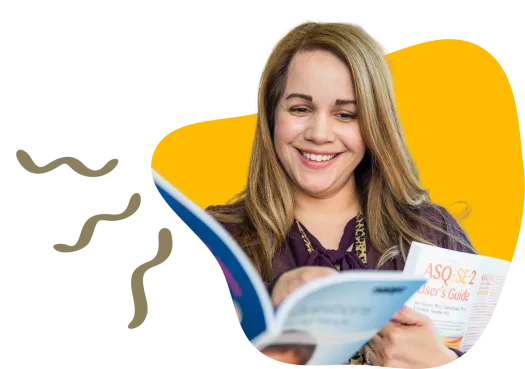 lady with long hair smiling at notebook